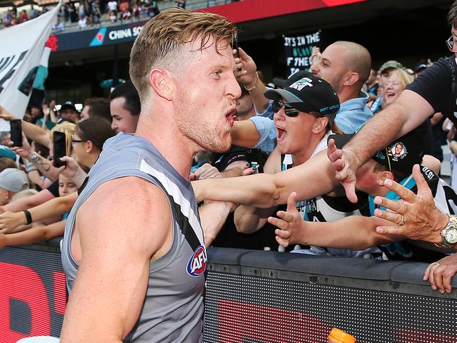 MELBOURNE, AUSTRALIA - MARCH 23: Tom Jonas of the Power   celebrates the win with fans during the round one AFL match between the Melbourne Demons and the Port Adelaide Power at Melbourne Cricket Ground on March 23, 2019 in Melbourne, Australia. (Photo by Michael Dodge/Getty Images)