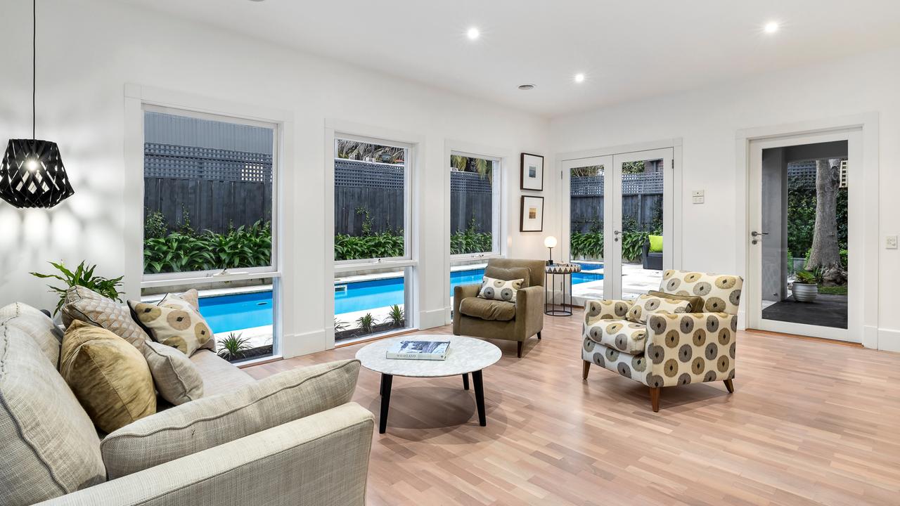 The spacious living area looking out to the swimming pool.