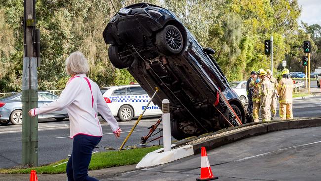 Crews attempting to bring the car down. Picture: Jake Nowakowski