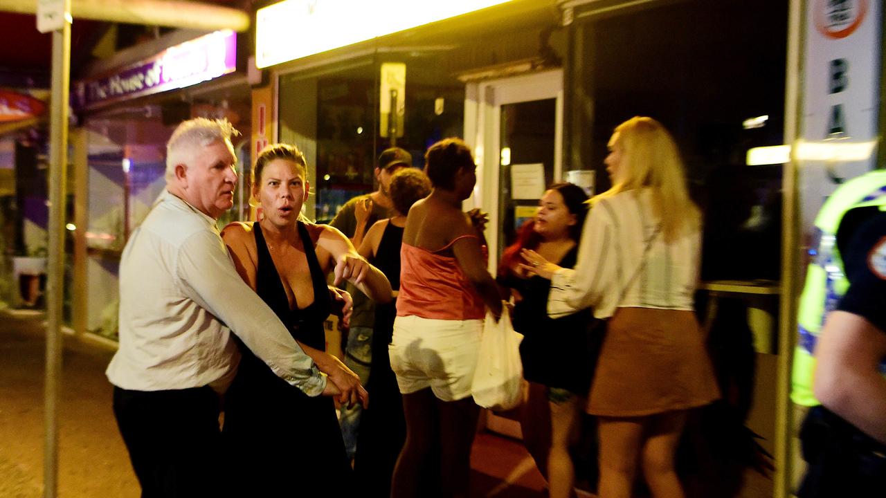 Revellers leaving a club have a crack at the media as police officers break up a fight on Mitchell street in the early hours of New Year's day