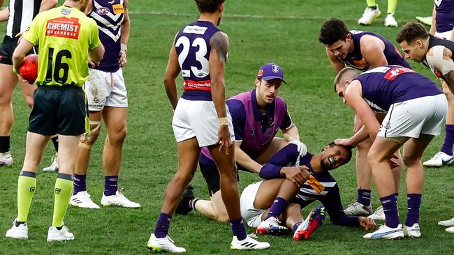 Brandon Walker holds onto his knee after a horror injury. (Photo by Dylan Burns/AFL Photos via Getty Images)