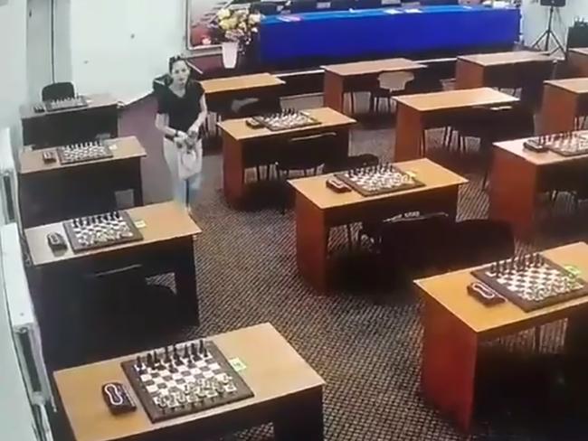 Russian chess pro Amina Abakarova has been accused of poisoning her rival after this CCTV emerged showing her seemingly interfere with a board before a tournament. Picture: East 2 West