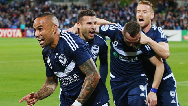 Archie Thompson of the Victory celebrates a goal with teammates.