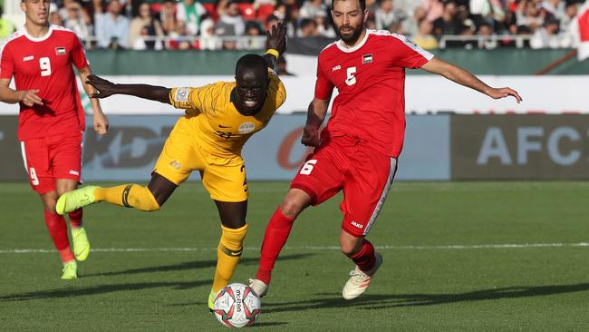 Socceroos forward Awer Mabil and Palestine midfielder Shadi Shaban contest the ball. Picture: AFP