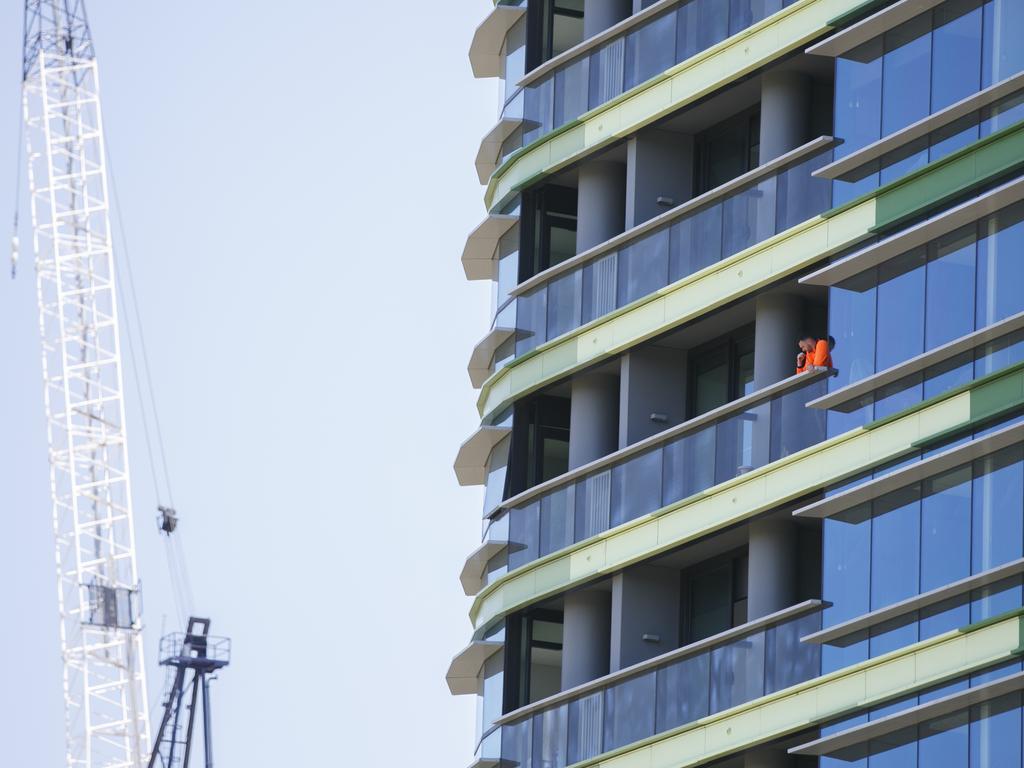 Workers carry out repairs on a 10th floor balcony of Opal Tower at Sydney Olympic Park after large cracks appeared. Picture: Tim Pascoe