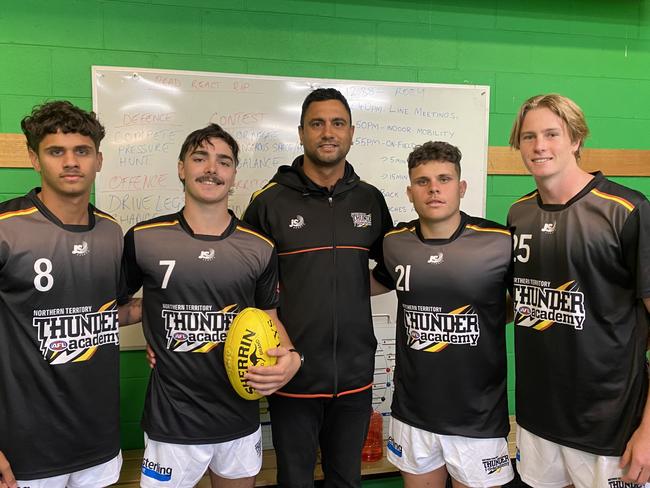 Thunder under-19 players Ronald Fejo Jr, Darcy Matricardi, Thomas Clarke and Jamie Jones with coach Jason Roe. Picture: AFLNT Media