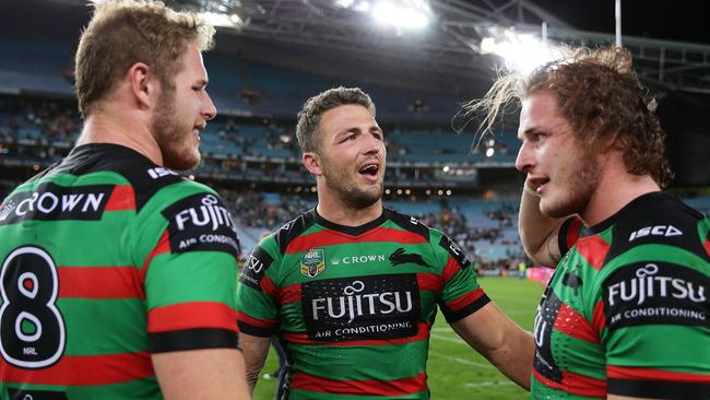 Sam Burgess (centre) with his brothers Tom (left) and George after a Souths victory. Picture: Brett Costello