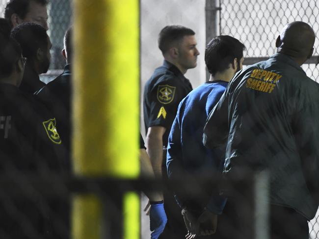 Esteban Santiago being transported to the Broward County Main Jail by authorities. Picture: Jim Rassol/South Florida Sun-Sentinel via AP