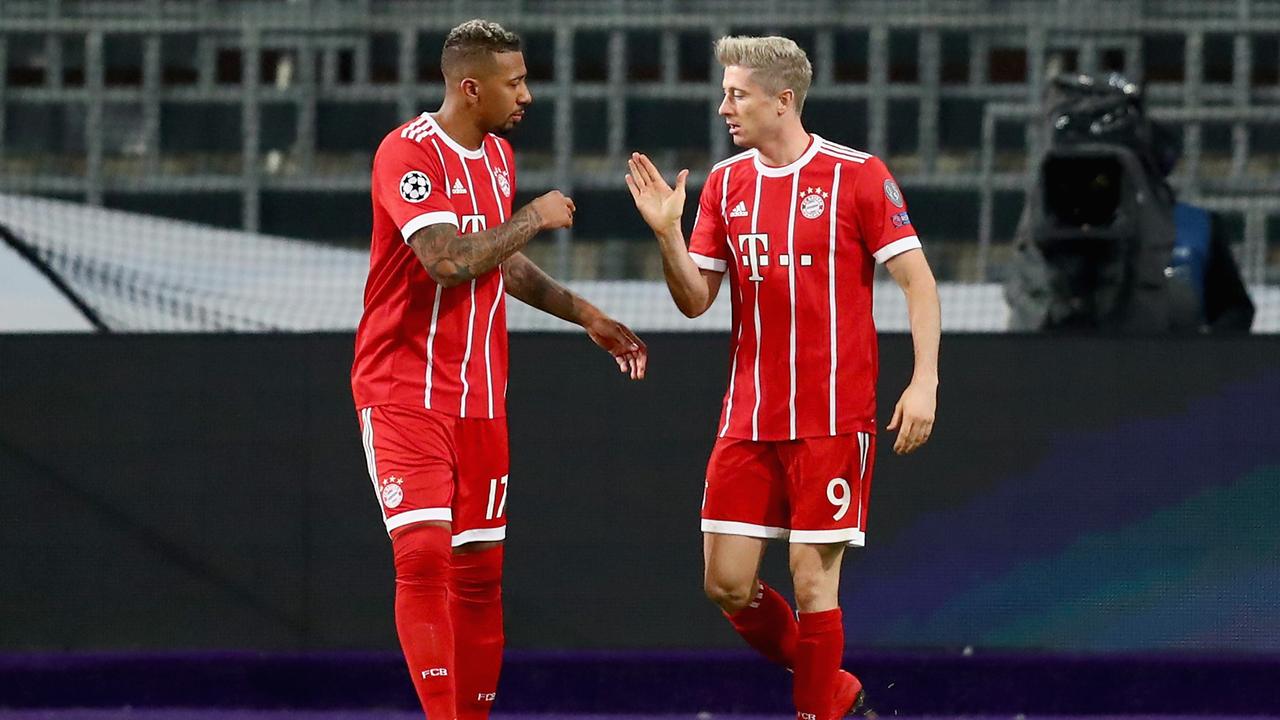 Jerome Boateng (L) congratulates opening goalscorer Robert Lewandowski during the UEFA Champions League.