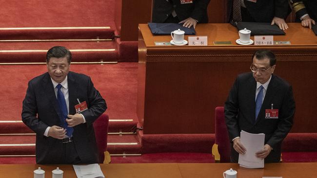 Xi Jinping, left, and Premier Li Keqiang at the end of the second plenary session of the National People's Congress at the Great Hall of the People on Monday in Beijing. Picture: Getty Images