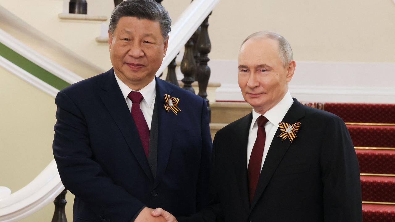 Russia's President Vladimir Putin greets Chinese President Xi Jinping prior to the Victory Day military parade in Moscow on May 9, 2025 local time. Picture: Mikhail Metzel / AFP