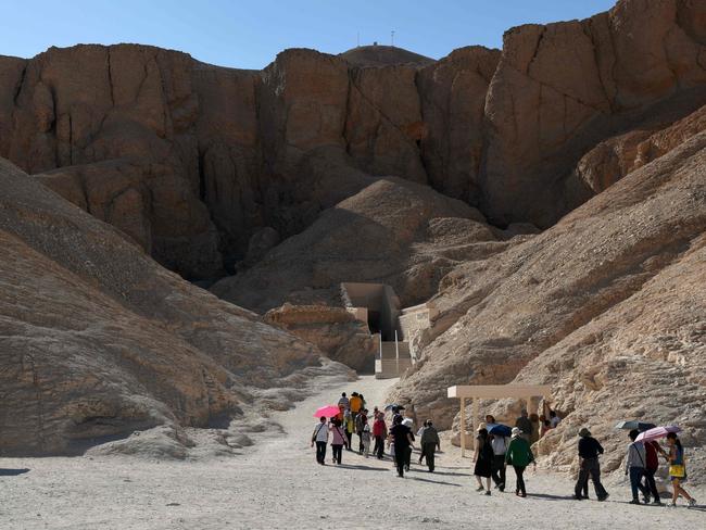 Tourists walk outside King Tutankhamun's tomb at the Valley of the Kings. If it is found to conceal the remains of legendary beauty Queen Nefertiti, as Egypt's antiquities minister hopes, it would produce a tourism boom. Picture: AFP