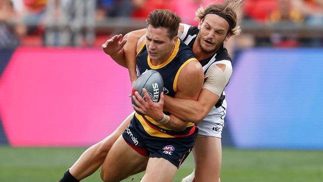 Jake Kelly is tackled by James Aish on Thursday. Picture: Getty Images