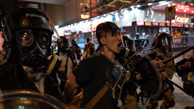 ‘The situation is really precarious’: A protester is arrested in Hong Kong early yesterday. More than 20 people have been charged. Picture: Getty Images