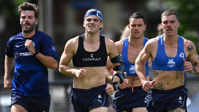 MELBOURNE, AUSTRALIA - NOVEMBER 17: Luke McDonald, Brayden George and Luke Davies-Uniacke and Cameron Zurhaar of the Kangaroos run laps during a North Melbourne Kangaroos AFL training session at Arden Street Ground on November 17, 2023 in Melbourne, Australia. (Photo by Quinn Rooney/Getty Images)