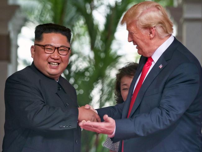 Kim Jong Un shakes hands with US President Donald Trump.