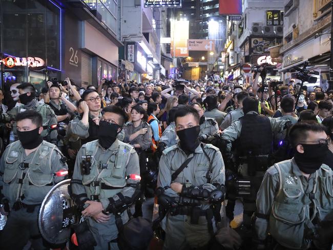 Police gather in Hong Kong as pro-democracy protesters urge people to celebrate Halloween by wearing masks in defiance of a government ban on face coverings. Picture: AP Photo