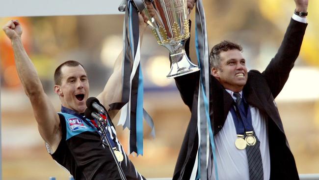 Port Adelaide’s Warren Tredrea and coach Mark Williams with the 2004 AFL premiership cup.