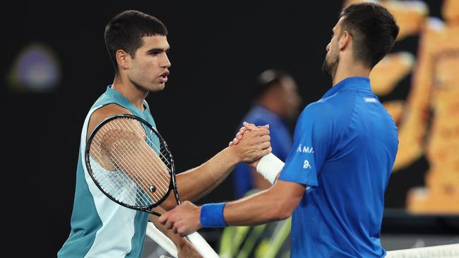 Spain's Carlos Alcaraz shakes hands with Serbia's Novak Djokovic after their men's singles quarterfinal match. (Photo by Martin KEEP / AFP)