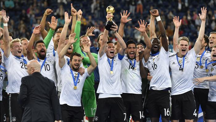 Germany's Julian Draxler, center, lifts the trophy after Germany won 1-0 in the Confederations Cup final soccer match between Chile and Germany, at the St.Petersburg Stadium, Russia, Sunday July 2, 2017. (AP Photo/Martin Meissner)