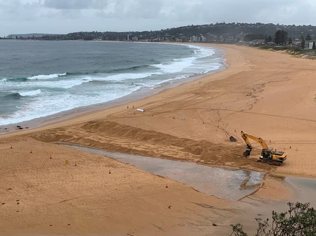 Northern Beaches Council regularly uses mechanical Diggers to open the entrance to Narrabeen Lagoon, at North Narrabeen Beach. File picture: Northern Beaches Council