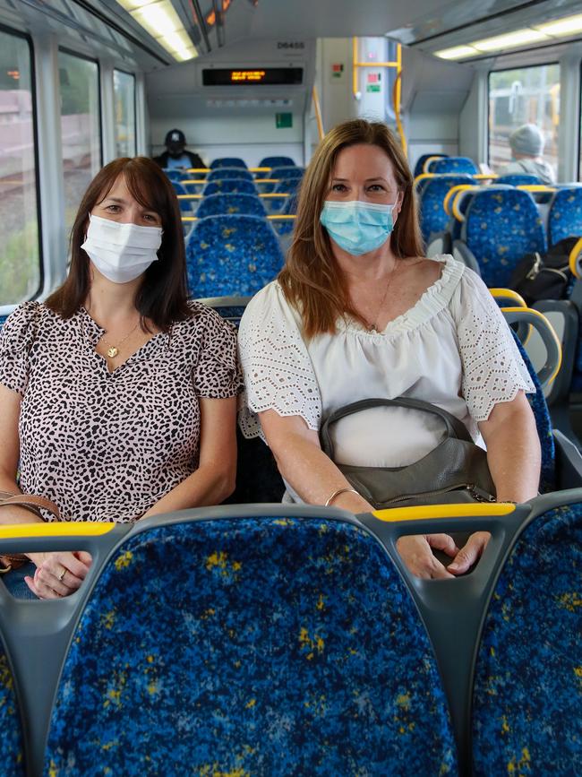 Julie Roberts and Megan Louise wearing masks on the train to Central on Sunday. Picture: Justin Lloyd