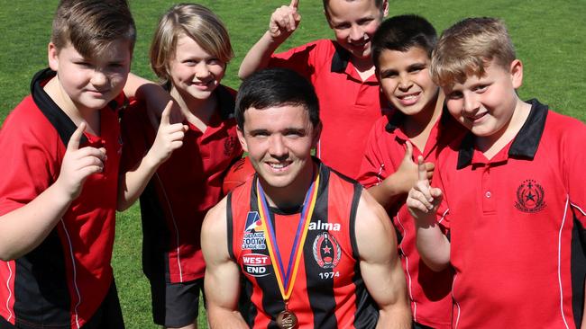 ROC footballer and Rostrevor College teacher Tim Baccanello with students (left to right) Miles, Oscar, Joe, Phillip and Ryan. Baccanello won the Keith Sims OAM Medal for best and fairest in the Adelaide Footy League's division one. Picture: Rostrevor College.