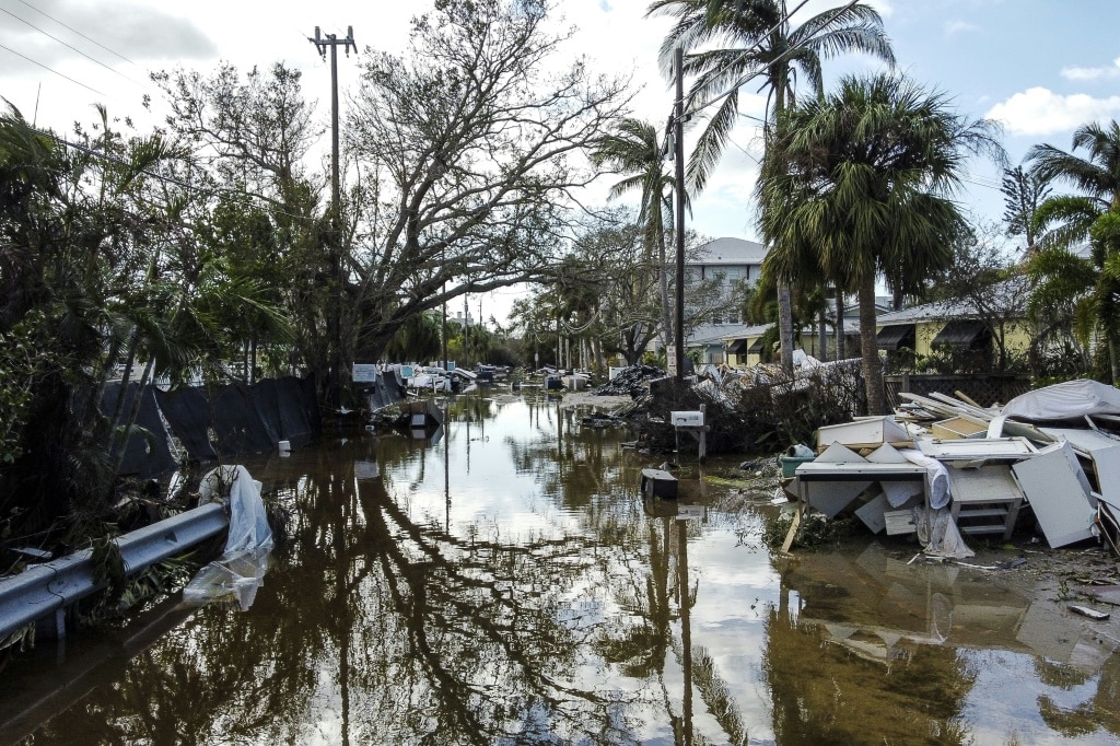 A flooded street with debris in the aftermath of Hurricane Milton in Siesta Key, Florida, where the storm made landfall