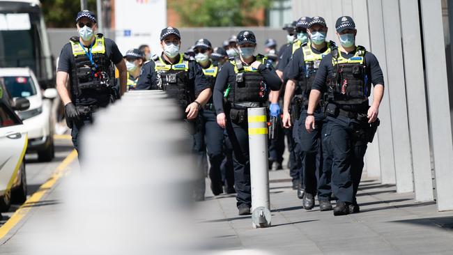 Police patrol the vaccination hub at the Melbourne Convention Centre. Picture: Tony Gough