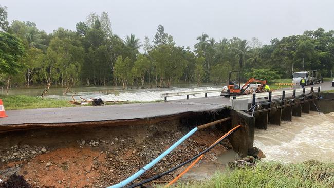 The Foxtail Av bridge leading into the Port Hinchinbrook estate was badly damaged by water flow through One Mile Creek. Picture: Matt Price