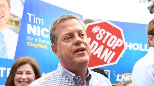 Queensland Opposition Leader Tim Nicholls is surrounded by Anti Adani protestors as he arrives to vote at St John Anglican Church in Hendra in his electorate of Clayfield on the final day of the Queensland Election campaign on Saturday, November 25, 2017. (AAP Image/Tracey Nearmy) NO ARCHIVING