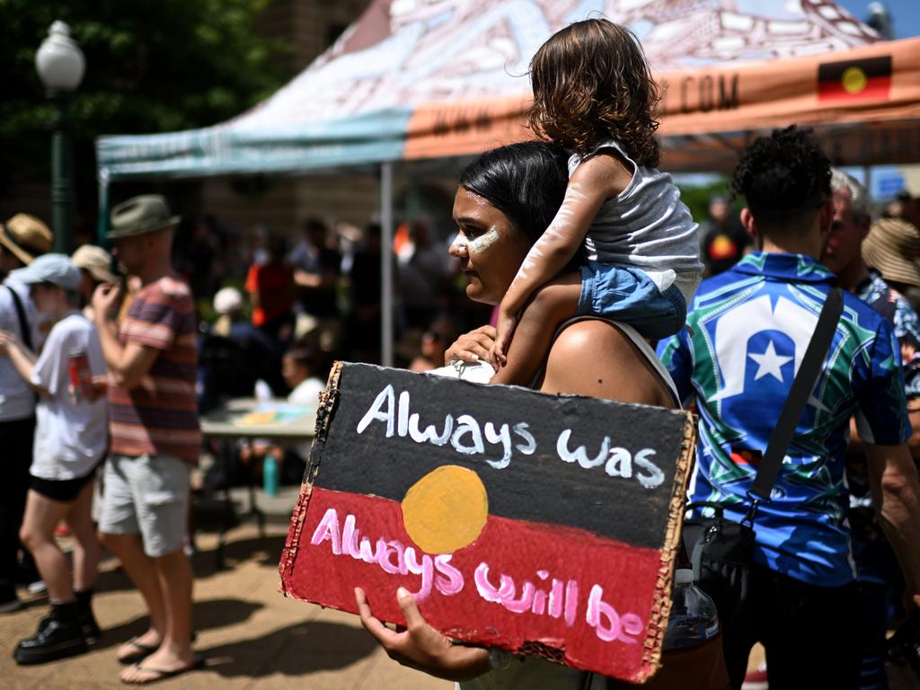 A woman holds a sign which says “always was, always will be”. Picture: NCA Newswire / Dan Peled