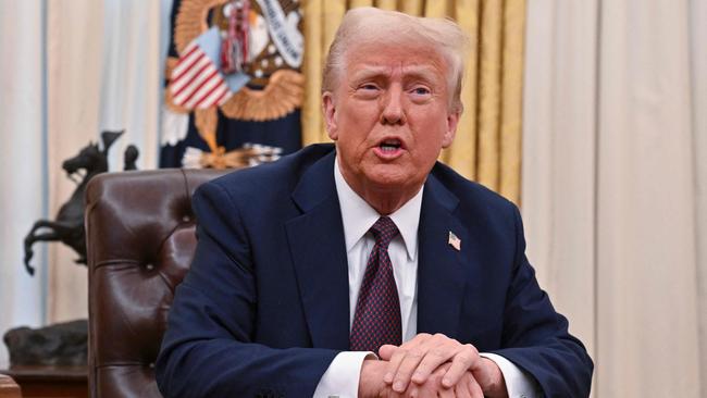 Donald Trump speaks to the media after signing Executive Orders in the Oval Office of the White House. Picture: AFP.