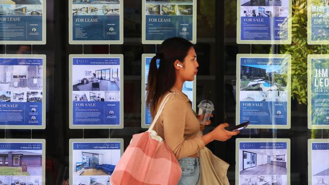 A pedestrian walks past a real estate agency in Sydney’s central business district.