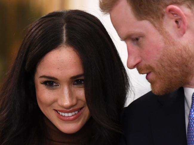 (FILES) In this file photo taken on January 10, 2020 Britain's Prince Harry, Duke of Sussex and Meghan, Duchess of Sussex react during their visit to Canada House in thanks for the warm Canadian hospitality and support they received during their recent stay in Canada, in London. - The Canadian government has yet to decide whether it will assume the security costs associated with Prince Harry and Meghan Markle's decision to split their time between Canada and Britain, Prime Minister Justin Trudeau said January 13, 2020. "I think that is part of the reflection that... needs to be had, and there are discussions going on," Trudeau said in an interview with Canadian television channel Global. (Photo by DANIEL LEAL-OLIVAS / various sources / AFP)