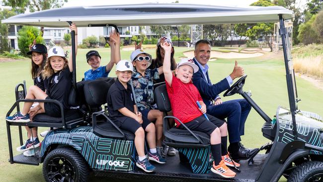 South Australian Premier Peter Malinauskas taking Ambrose and some young golfers for a spin in the Liv Golf buggy at the Liv Golf Family Fairway Media Call at Grange Golf Club, Adelaide. Picture: Kelly Barnes