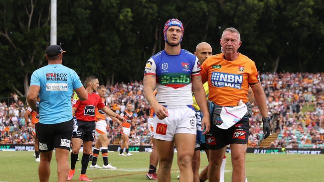 Kalyn Ponga of the Knights leaves the field for an HIA (Photo by Cameron Spencer/Getty Images)