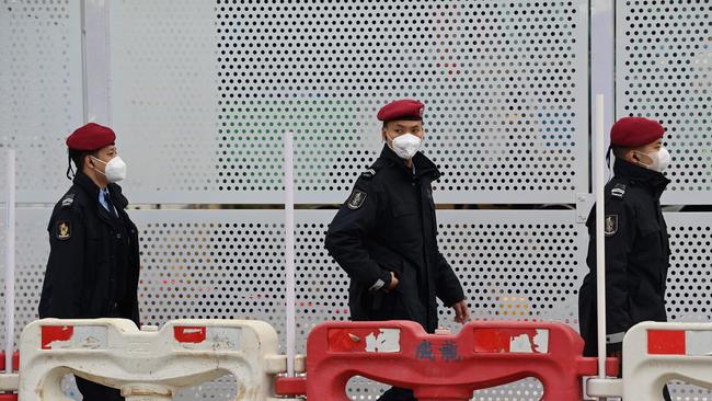 Policemen patrol outside the courthouse in Macau ahead of the arrival of junket boss Alvin Chau. Picture: Peter Parks/AFP