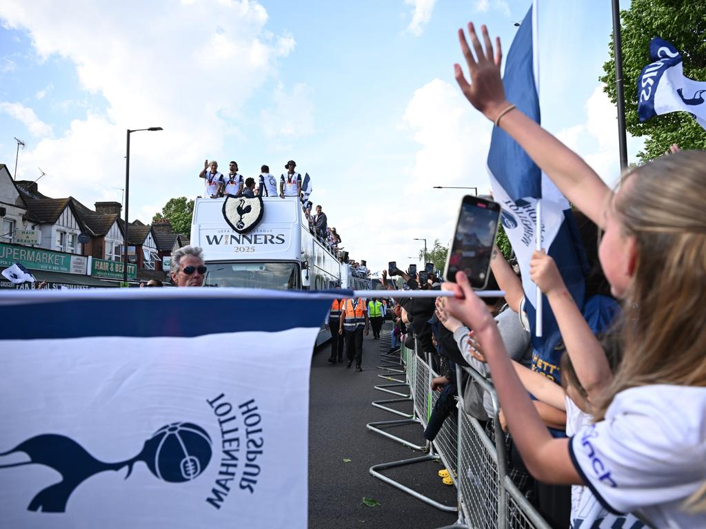 A little girl waves excitedly at the team bus. Picture: Getty Images