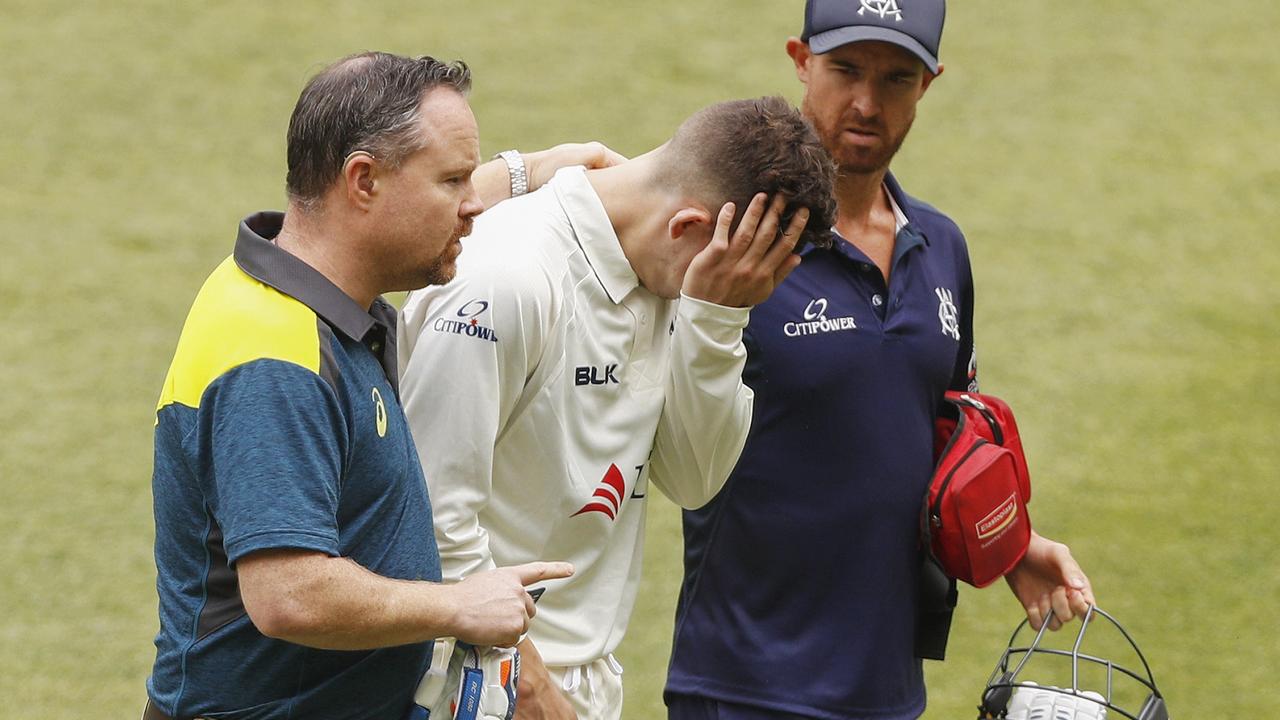 Nic Maddinson of Victoria leaves the field injured after being struck by the ball on his arm.