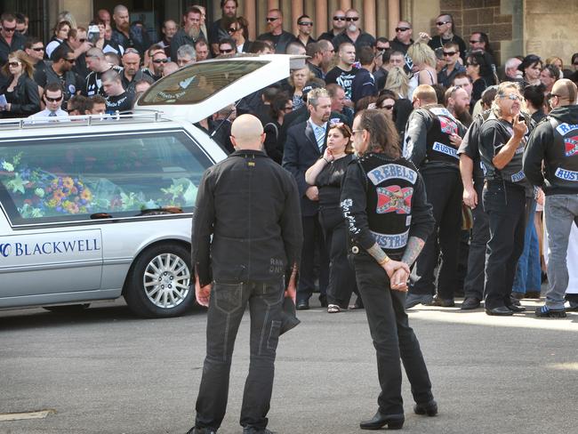 The hearse is covered in bright flowers.