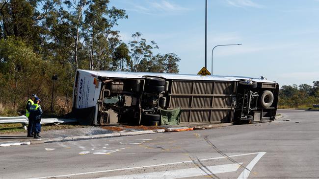 The overturned bus on the Greta roundabout. Picture: David Swift