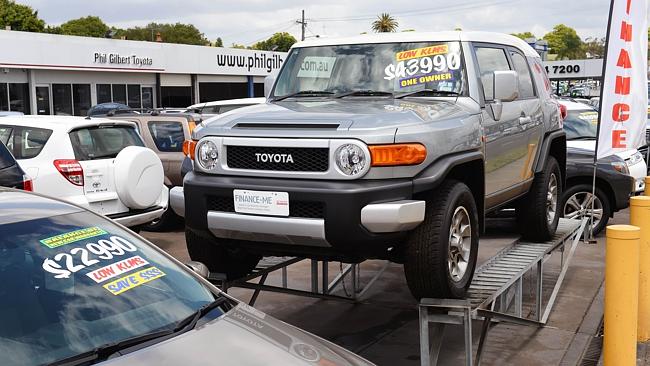 Waiting their fate .... a Toyota vehicle is displayed at a Toyota dealership in Sydney as Australian Prime Minister Tony Abbott sought talks with Toyota to persuade the Japanese giant to keep its plants open Picture: AFP 