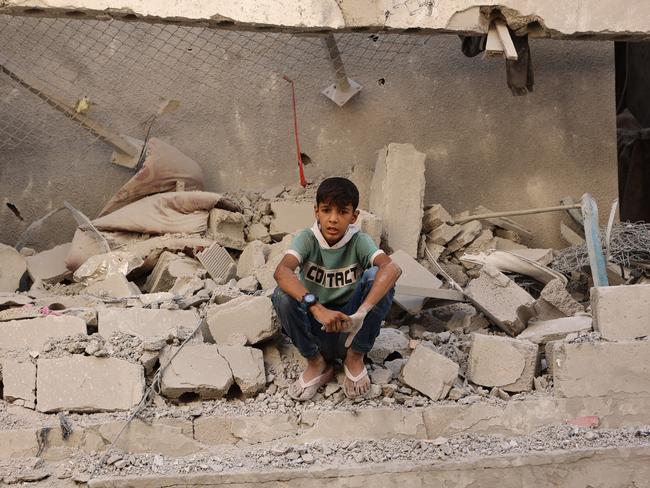 A Palestinian boy sits among the debris at the site of an Israeli strike on a school housing displaced Palestinians in Gaza City's Zaytoun neighbourhood on September 21. Picture: Omar Al-Qattaa/AFP