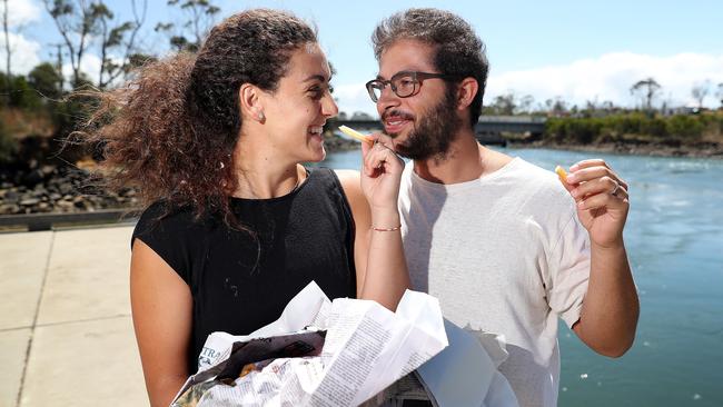 Mexicans Bertha Duek, left, and Jacob Romano try the Fish and Chips from the Dunalley Fish Market. Picture: SAM ROSEWARNE.