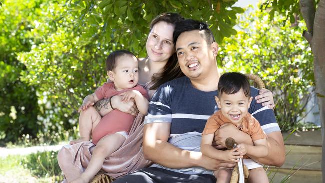 Motorbike accident survivor Henry Sun, third from left, pictured with son Oscar, 1, partner Kirsten and son Archie, 2, has recounted the terrifying moment he was struck by a car as he calls for drivers to be careful on the roads these holidays. Picture: Renae Droop