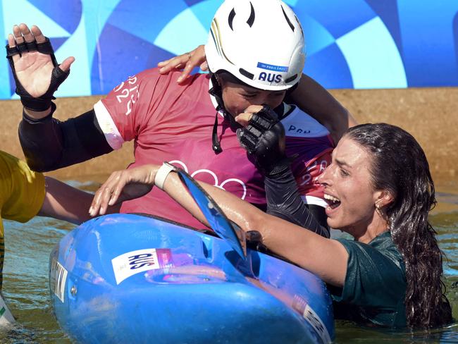 Jess Fox congratulates her sister Noemie Fox after winning the women's kayak cross final. Picture: AFP