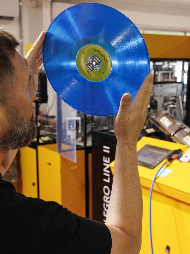 Neil Wilson examining a record pressed by his Allegro II at Suitcase Records. Picture: Glenn Hunt