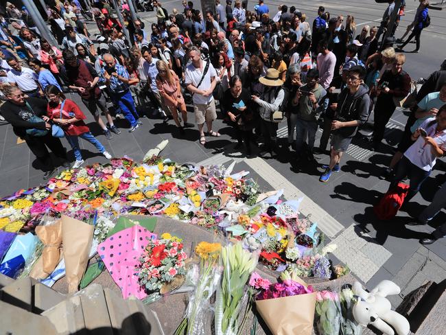 People showing their respects on the corner of Burke and Elizabeth streets. Picture: Alex Coppel