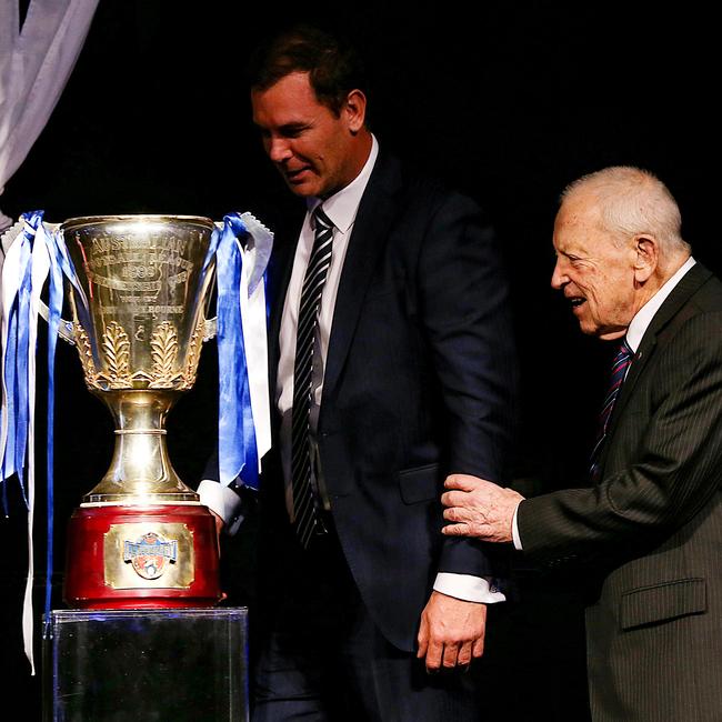 Wayne Carey and Allen Aylett on stage with North Melbourne’s 1996 Premiership cup. Picture: Ian Currie